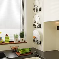 Organized Kitchen With Hanging Pot Lids And Fresh Herbs On Countertop