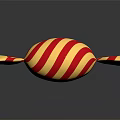 Red and White Striped Candy Wrapped in Gold Foil with Shiny Reflection on Black Surface
