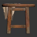 Round Wooden Stool with a Beige Cloth Draped Over the Seat and Solid Legs