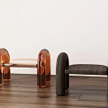 Modern Transparent Orange And Dark Brown Wooden Stools On Wooden Floor