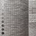 Structural Brick Wall Components Featuring Circular Openings And Varied Texture Patterns