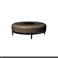 Round Beige Upholstered Ottoman Featuring Central Opening And Dark Slim Legs