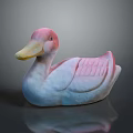 Pink and White Duck Decorative Figurine With Yellow Beak And Textured Wings On Dark Surface