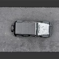 White Jeep With Black Soft Top Open Doors On Gray Pavement
