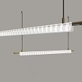Modern Linear Chandelier With White Cylindrical Shades And Gold Metal Frame Hanging In Interior