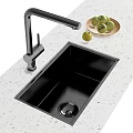 Sleek Black Kitchen Sink With Black Faucet On Light Patterned Countertop And Fresh Fruits Plate