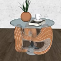 Glass Top Coffee Table With Orange Grey Curved Base Potted Plant White Cup And Books