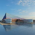 Unique Waterfront Building with Geometric Shape Colorful Glass Facade and Water Reflection under Blue Sky