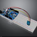 Blue Electronic Circuit Board With White Breadboard Connecting Wires And Components