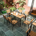 Cozy Villa Balcony With White Parasol Wooden Tables Chairs Green Plants And Brick Wall