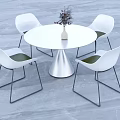 Modern White Round Dining Table With Four White Chairs Black Legs Green Cushions And Vase