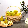 Fresh Ripe Pears in Wicker Basket with Sliced Pears and Roses Vase on Gray Tabletop