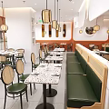 Bright Modern Japanese Restaurant Interior With Terrazzo Tables Rattan Chairs And Comfortable Green Booths