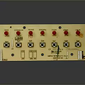 Control Panel with Black Knobs Square Buttons and Labels on Beige Surface