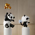 Panda Landscape Sculptures on White Pillars Featuring Gold Decorations and Blue Object on Wooden Wall