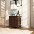 Dark Wooden Nightstand With Light Blue Lamp Small Clock And Decorative Bottle On White Wall