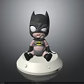 Cute Baby Batman Toy Figure Sitting On White Base With Pink Outfit And Logo