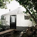 White Dome Canopy Tent with Diamond Pattern Windows and Wooden Stairs in Natural Outdoor Area