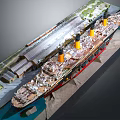 Detailed Ship Model with Yellow Funnels Red Hull in Dockside Diorama Including Railway Track