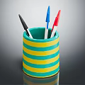Colorful Pen Holder With Yellow And Green Stripes Containing Various Colored Pens