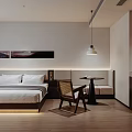 Minimalist Hotel Guest Room With King Bed Wooden Chair Wall Art And Soft Lighting