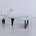 Modern Glass Top Coffee Table with Black Metal Legs and Decorative Vase with Twigs