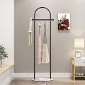 Stylish Modern Clothes Hanger with Hanging Dresses and Tops in Bright Living Room