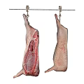 Two Raw Meat Carcasses Hanging On Metal Rod With Hooks Against Black Background