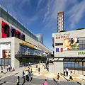 Modern Commercial Complex With Tall Buildings Brand Stores Leisure Plaza Pedestrians And Decorative Balloons