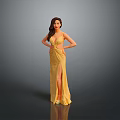 Elegant Woman Posing With Hands On Hips In Yellow Dress With Slit Against Gray Background