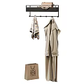 Stylish Beige Coats Hanging On Rack With Scarf And Paper Bag