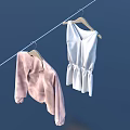 Clothes Hanging on Clothesline with Pink Coat White Dress and Wooden Hangers Against Blue Background