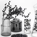 Glass Vases and Decorative Jars with Black Berries in Woven Basket and Pitcher