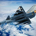 Modern Fighter Jet Flying Over Clouds With Missiles And Military Insignia