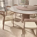 Modern Dining Room With Round Wooden Table And Woven Seat Chairs On Light Wooden Flooring
