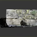 Layered Natural Rock Formation With Green Moss Covered Surface And Small Cave