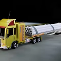 Yellow Utility Truck With Long Trailer Carrying Cylindrical Pipes on Road
