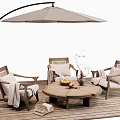 Wooden Outdoor Chairs With Armrests And Cushions Near Round Table And Umbrella