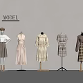 Model Mannequins Displaying Neutral Tones Dresses And Plaid Coats Against Grey Wall