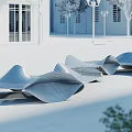 Wave Shaped Metal Landscape Seating in Plaza with White Buildings Trees and Street Lamps