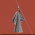 Patterned Cotton Towel Hanging On Metal Hook Against Pink Background