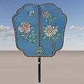 Blue Decorative Fan with Floral Patterns and Butterfly Design Black Handle Against Sky Background