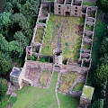 Ancient Castle Ruins Aerial View With Stone Walls And Surrounding Trees