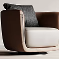 Brown And White Accent Chair With Gray Patterned Pillow And Black Round Swivel Base