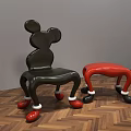 Mickey Shaped Black And Red Leisure Chairs With White Decorated Legs On Wooden Floor