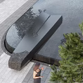 Modern Garden Landscape Design With Black Water Feature Paved Ground And Person Walking