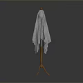 Wooden Coat Rack With Gray Knitted Shawl On Simple Dark Background