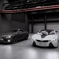 Black Audi Coupe and White BMW i8 Concept Cars in Industrial Garage Space