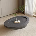 Modern Oval Dark Wooden Coffee Table With Open Book Glass Vase Plant On Light Carpet