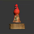 Red Bird Statue Decorative Figurine With Orange Base And Floral Patterns